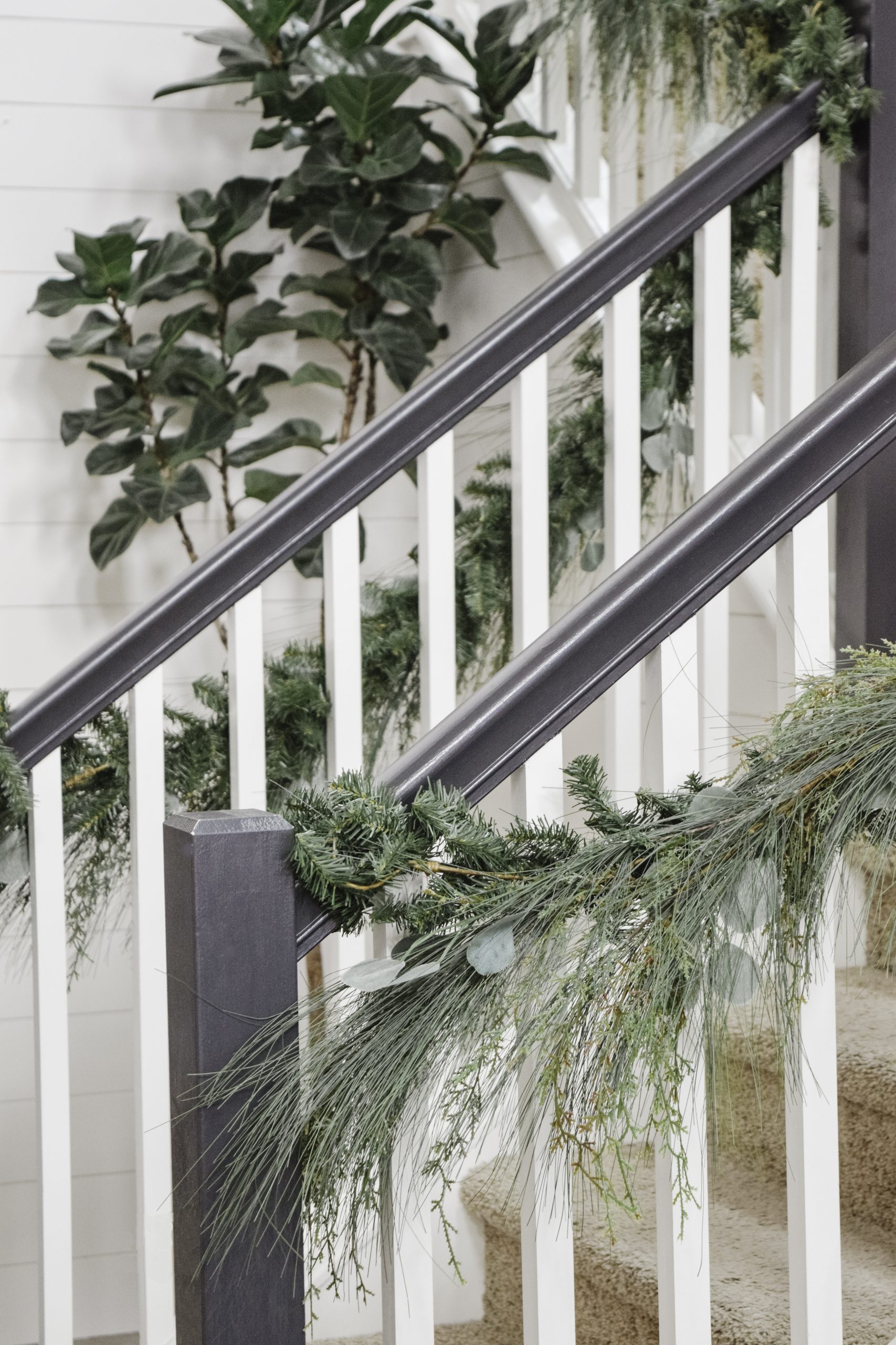 wispy garland style at black and white stair railing