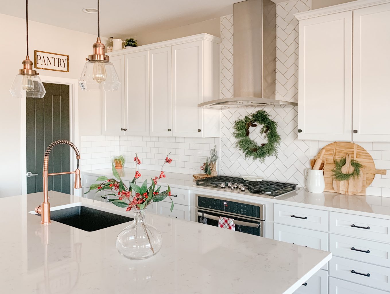 Kitchen with a christmas wreath over the stove 