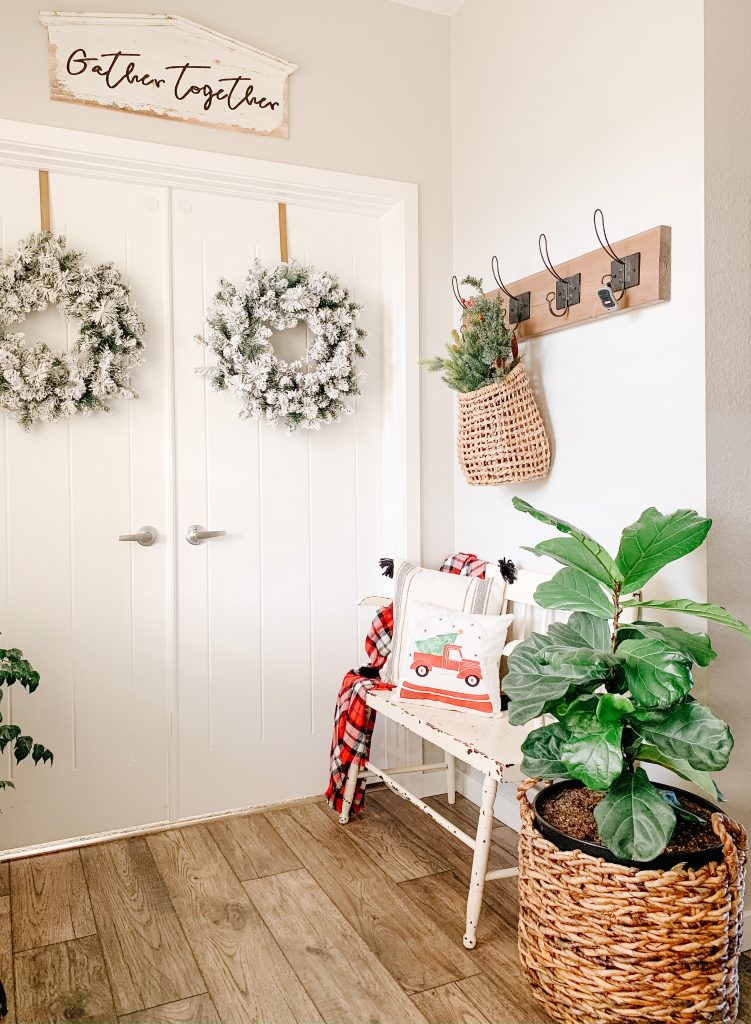 entryway bench with christmas decor around