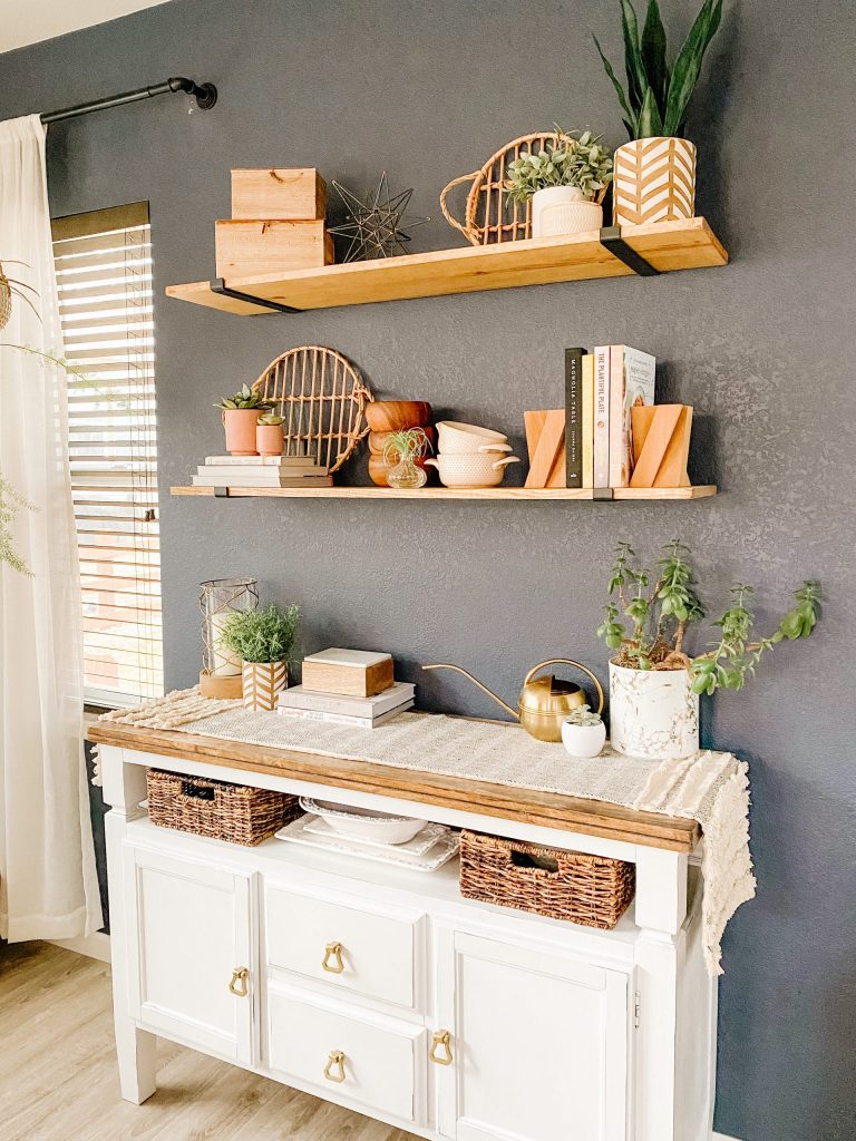 stained wood shelves with black brackets and white buffet cabinet