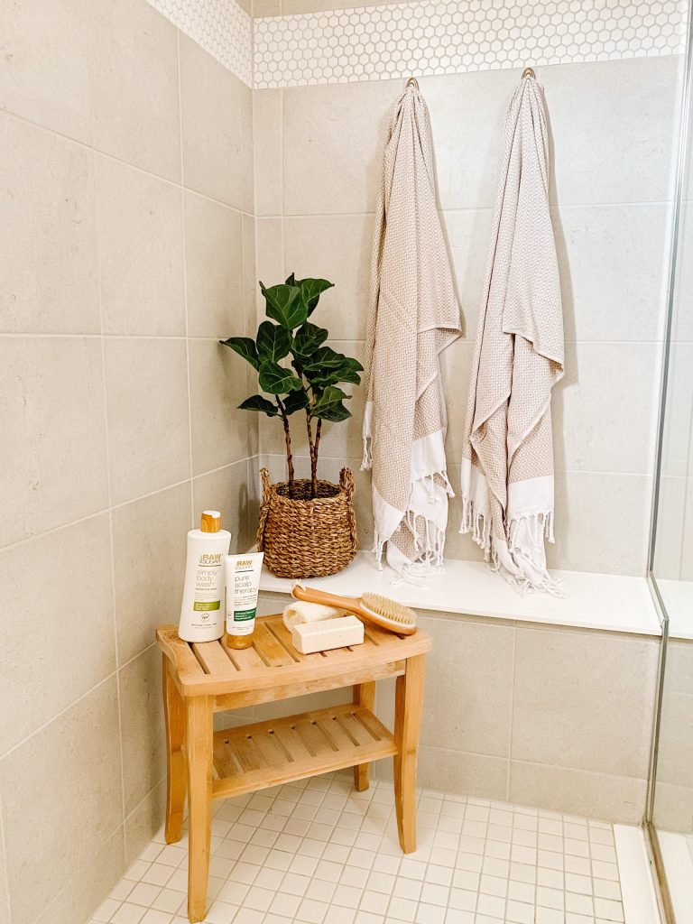 grey tile shower with teak bench taupe turkish towels and fiddle leaf fig