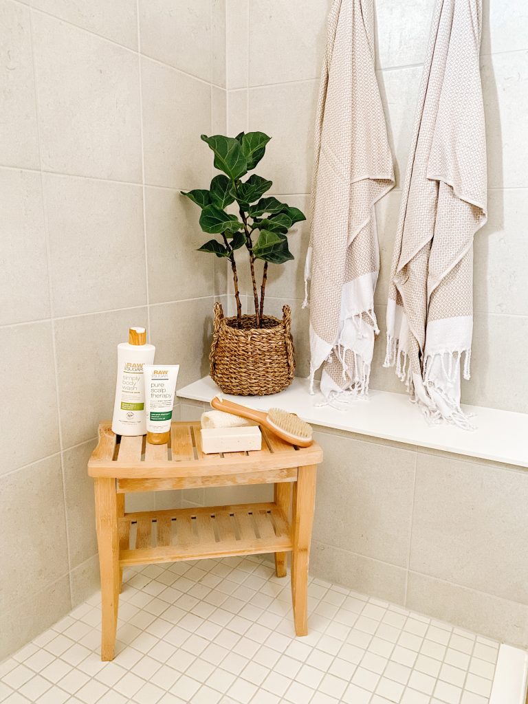 grey tile shower with teak bench taupe turkish towels and fiddle leaf fig