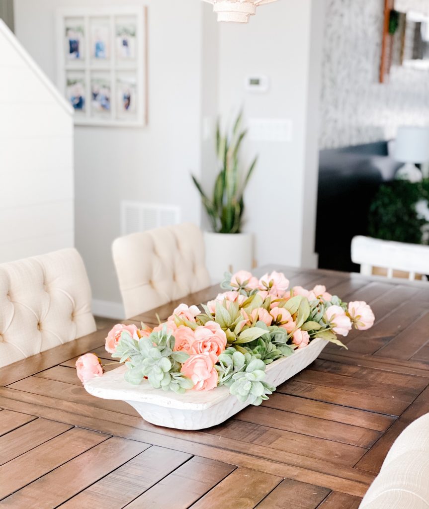 Simple Spring Centerpiece. Faux spring florals and faux greenery in a large antique dough bowl. 