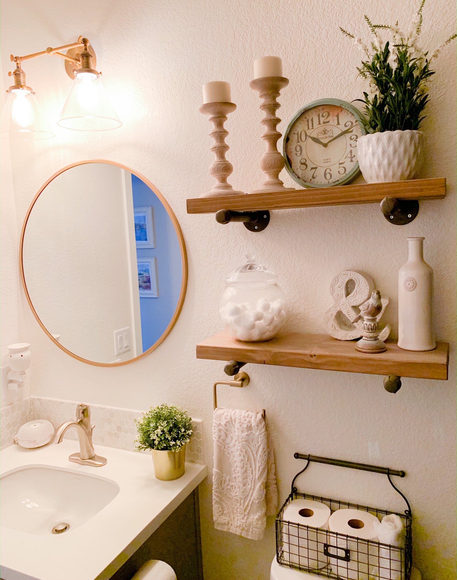 Powder Room with round gold mirror. An easy way to customize your bathroom with these 7 budget friendly bathroom mirrors from Target 