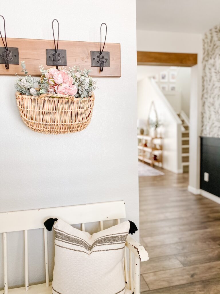 Spring florals in a basket hanging in the entryway adds a fresh spring feel! 