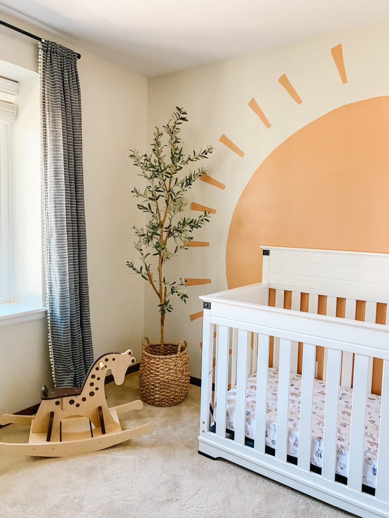 Boho Gender Neutral Nursery decor with faux olive tree and sun mural