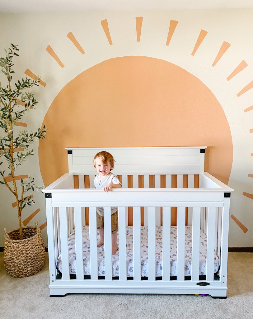 boho boy nursery decor with faux olive tree and sun mural
