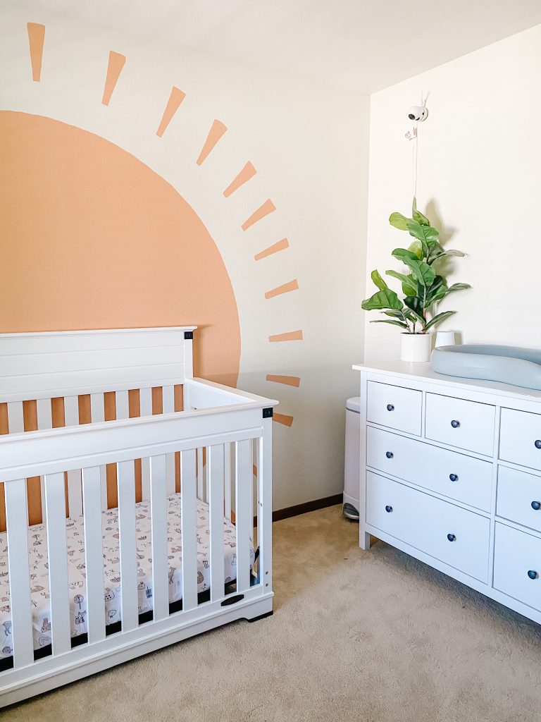 Boho Gender Neutral Nursery decor with white dresser and sun mural
