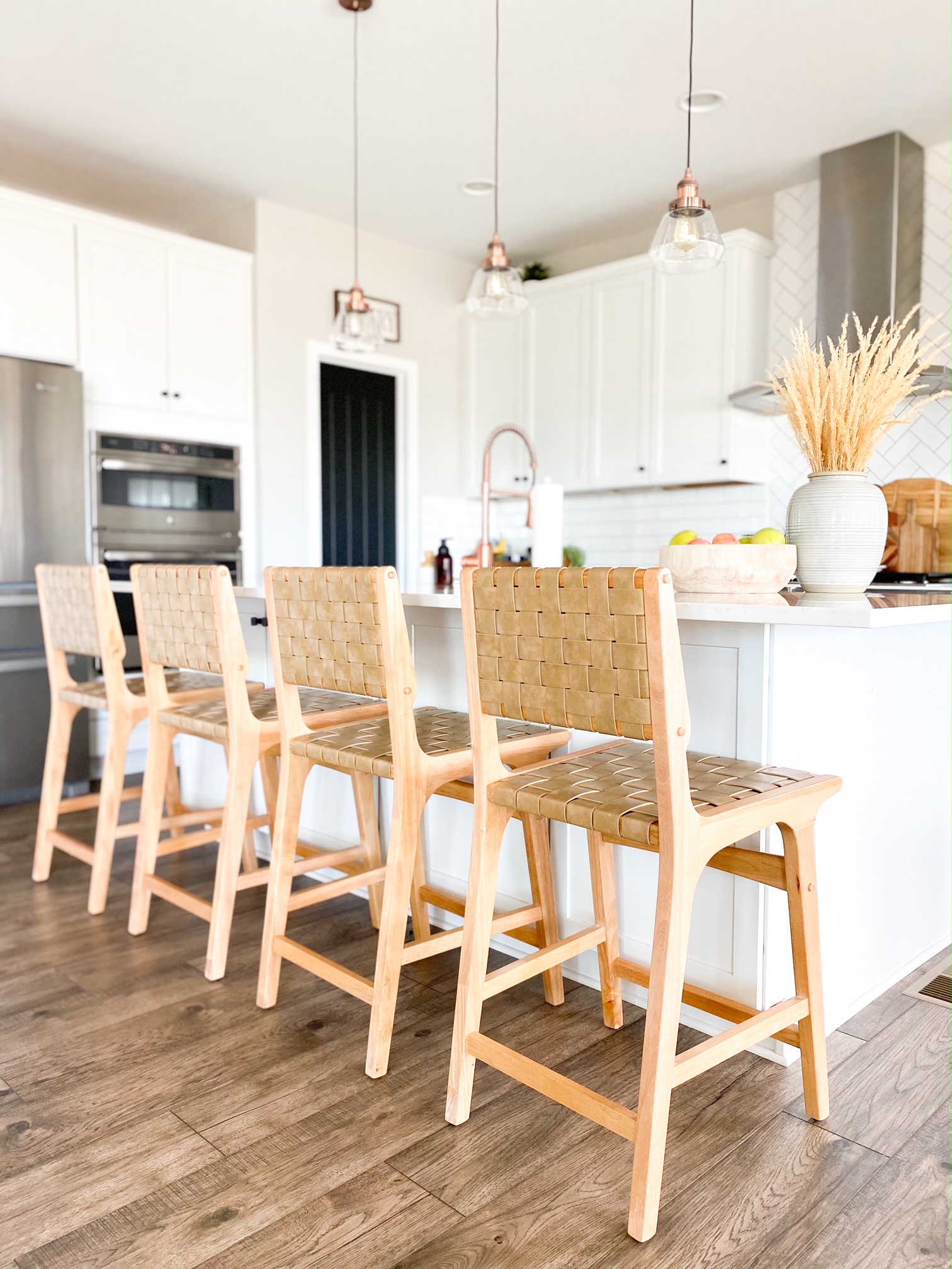 boho bar stools in an all white kitchen