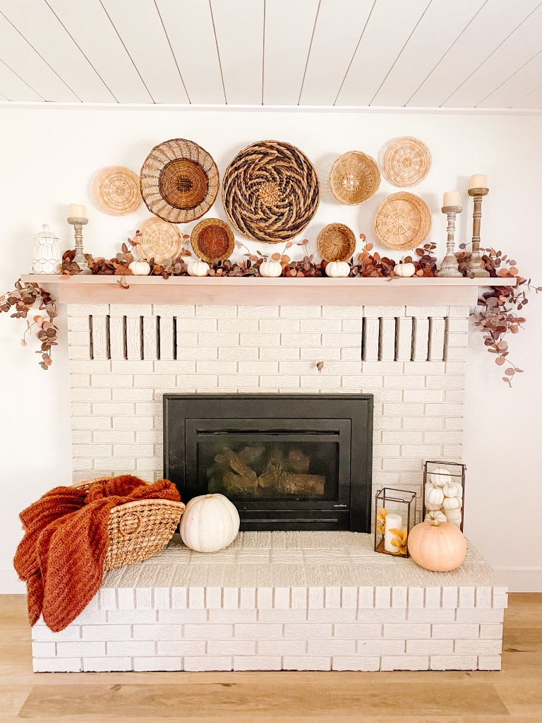 simple fall fireplace mantel with fall garland and white pumpkins