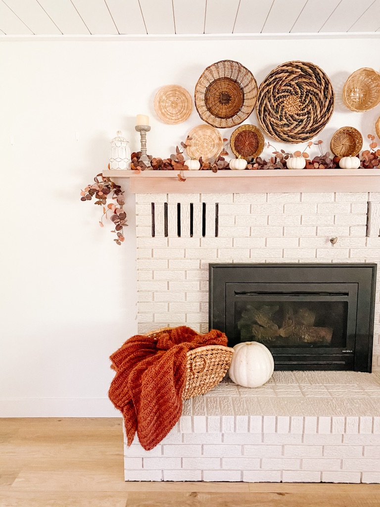 simple fall fireplace mantel with rust throw and baskets