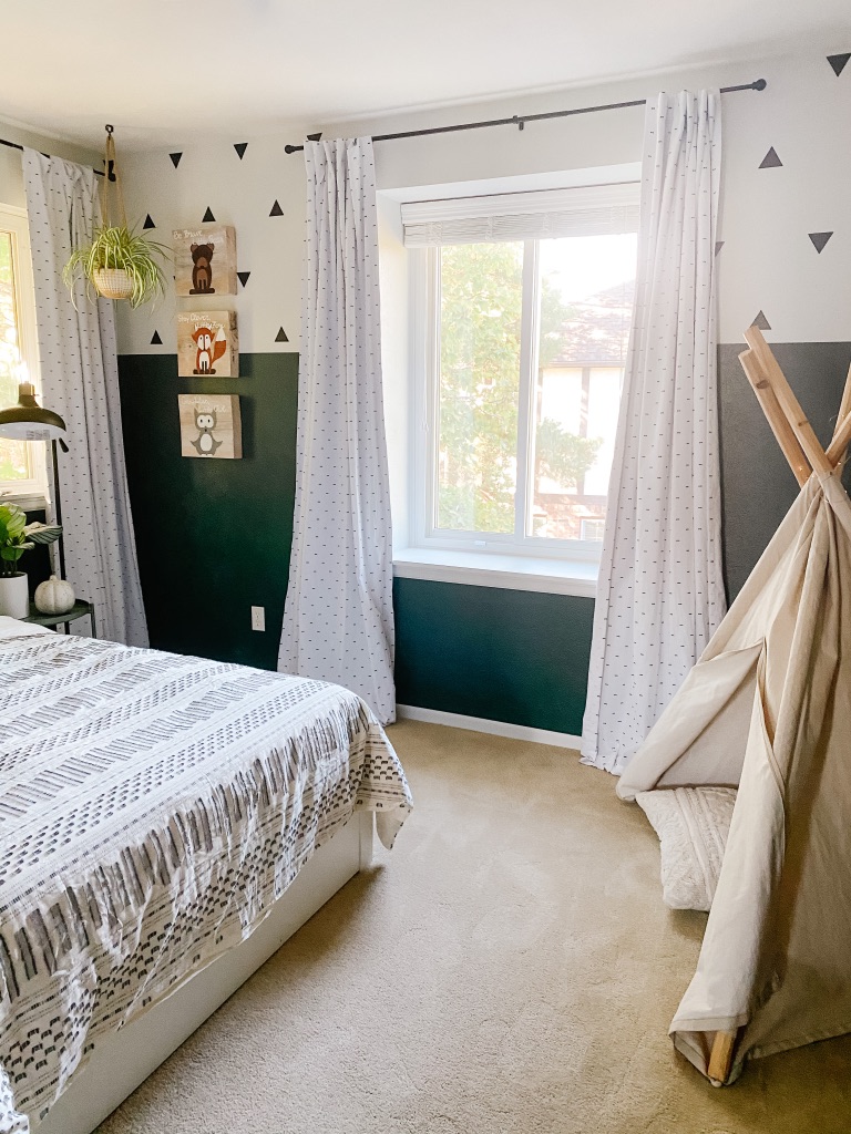 boys boho bedroom idea with colorblock green and white wall and white frame gallery wall