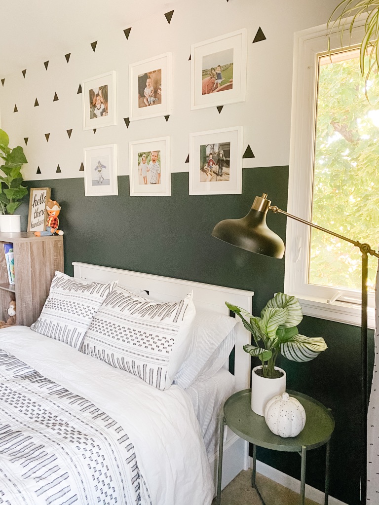 boho boy bedroom with colorblock green and white wall and white frame gallery wall