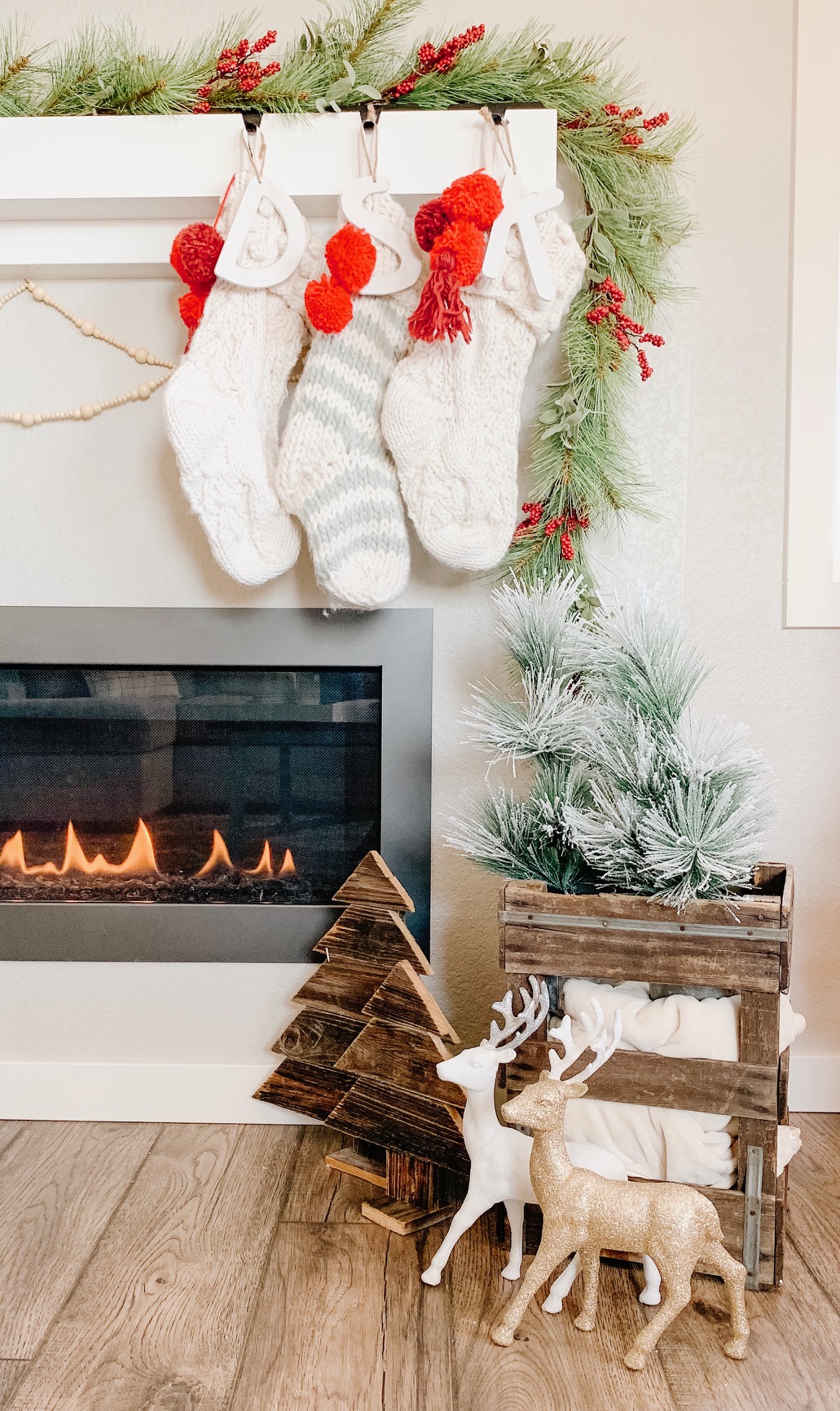 christmas fireplace mantel with stockings and bead garland