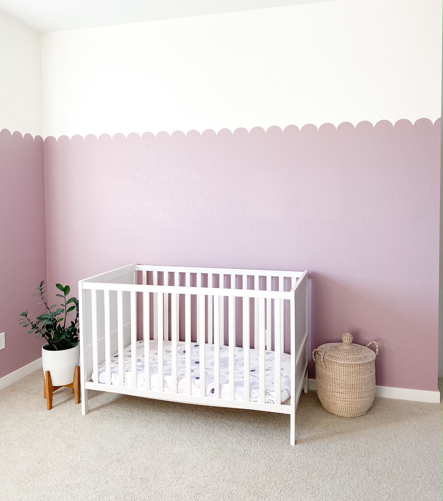 nursery with white crib and purple walls