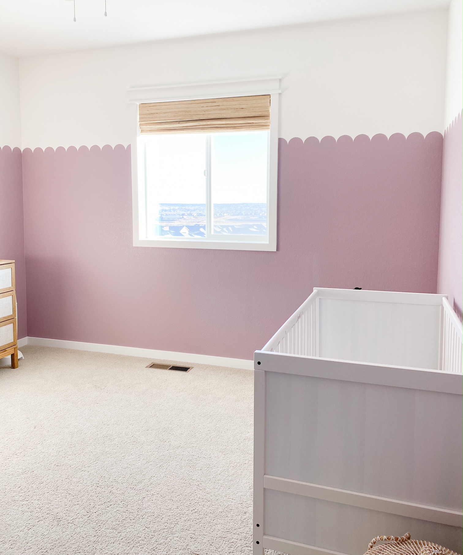 nursery with purple scalloped wall