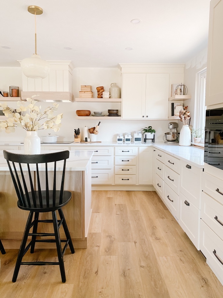 Provenza LVP floors in updated kitchen with white cabinets and quartz countertops