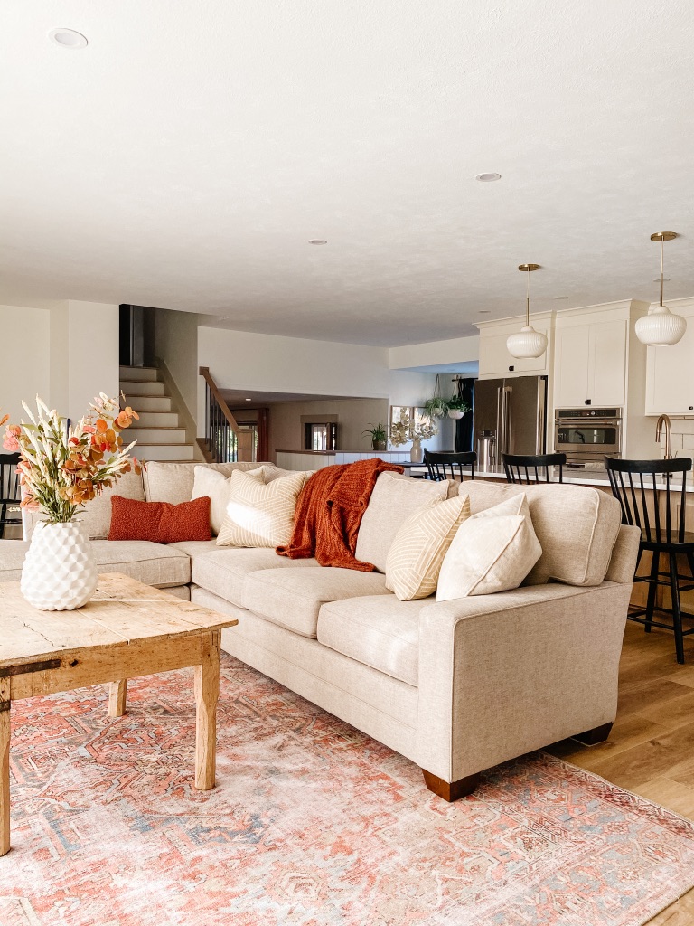 Woodley's King Hickory Sectional in neutral boho living room with loloi terra cotta area rug