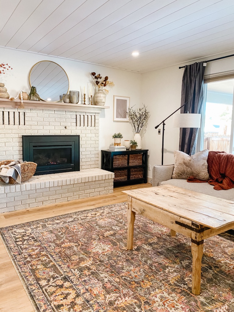 loloi chris loves julia rosemarie stone multi area rug in modern boho living room with painted brick fireplace