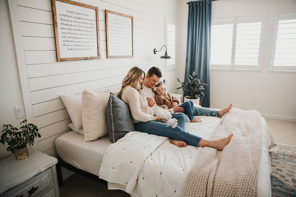 Cuddling up on the bed makes for some great candid newborn photos!