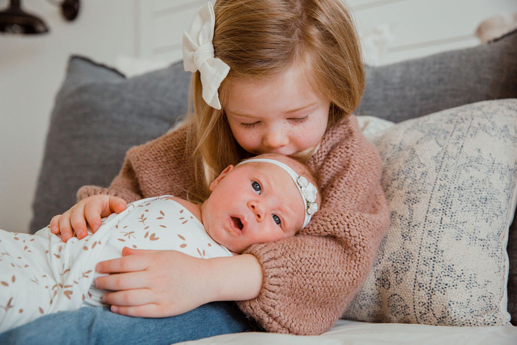 Make sure the older siblings feel special and included in the newborn photoshoot too!