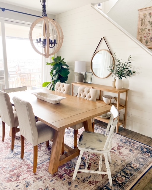 Affordable farmhouse dining table with fabric tufted chairs.