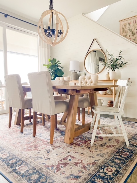 Dining room with neutral pattern rug and affordable dining room furniture. 