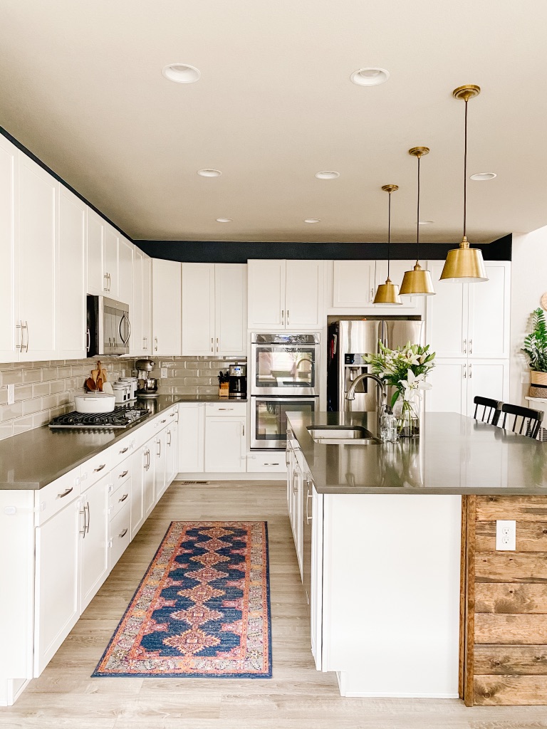 a colorful kitchen runner brings character into a neutral kitchen