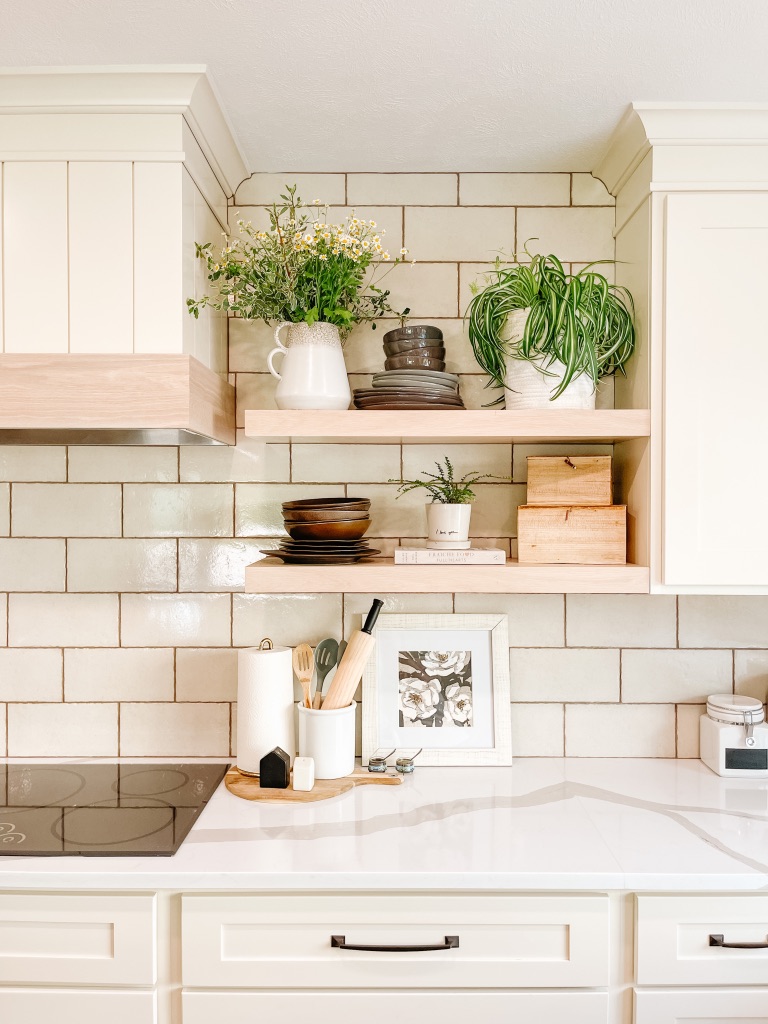 kitchen remodel with beige subway tile backsplash and white oak floating shelves and custom hood cover with shiplap and wood accent