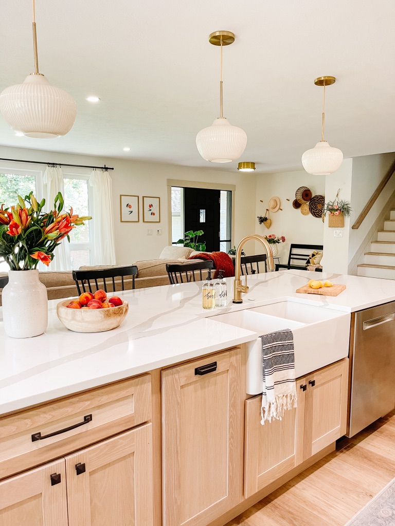 white farmhouse sink with gold faucet