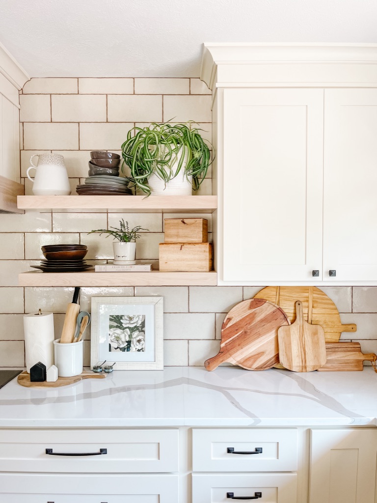 decorate your kitchen countertops with wooden cutting boards, frames, plants and kitchen canisters