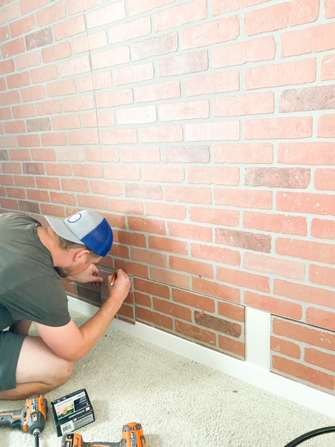 Installing, hanging and cutting faux brick paneling.