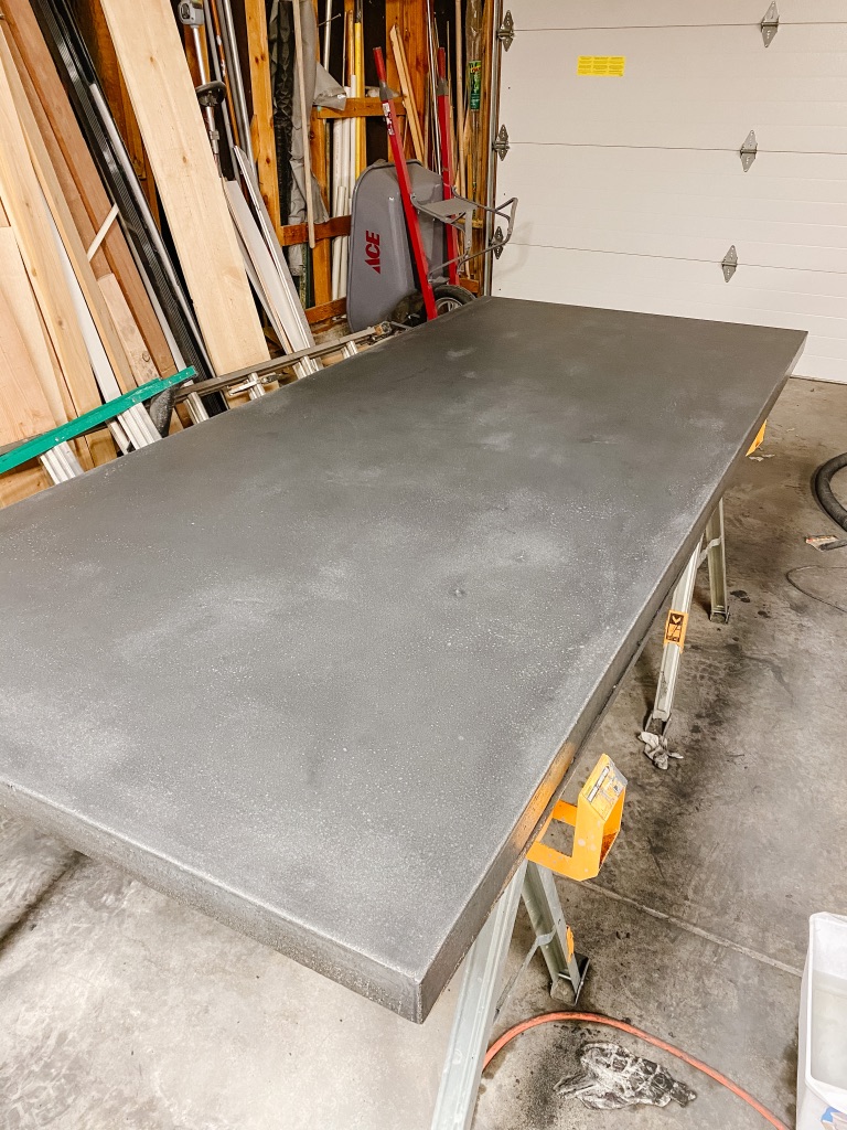 black diy concrete dining table top after sanding