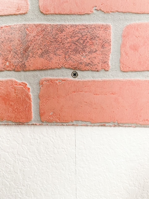 How to screw in a faux brick panel.