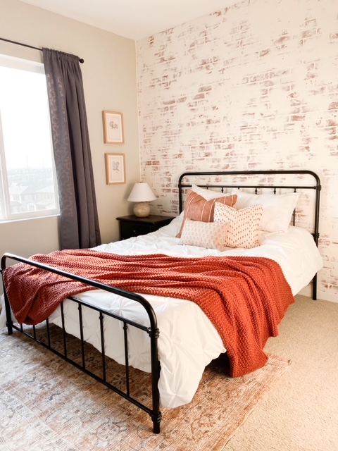 Guest bedroom with a German schmear faux brick wall.