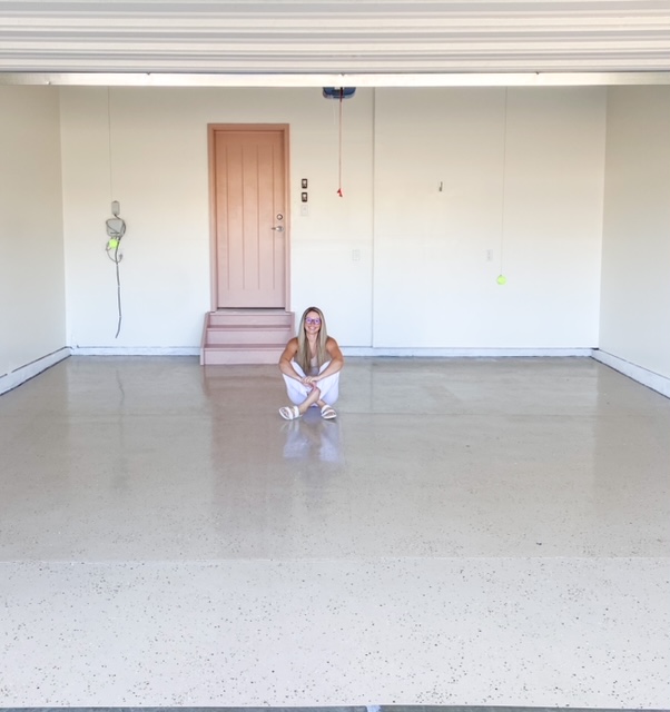 garage makeover after applying epoxy and painting walls and the door.