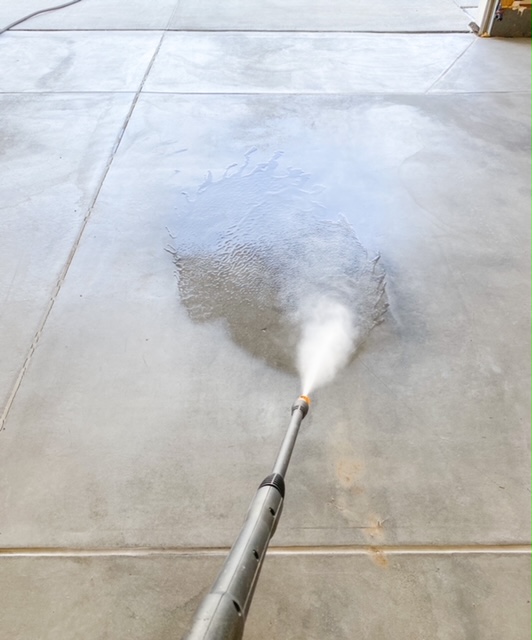 pressure washing garage floor to get ready to apply epoxy