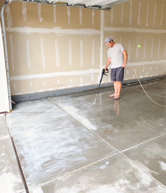 spraying off etch to get ready to epoxy garage floors