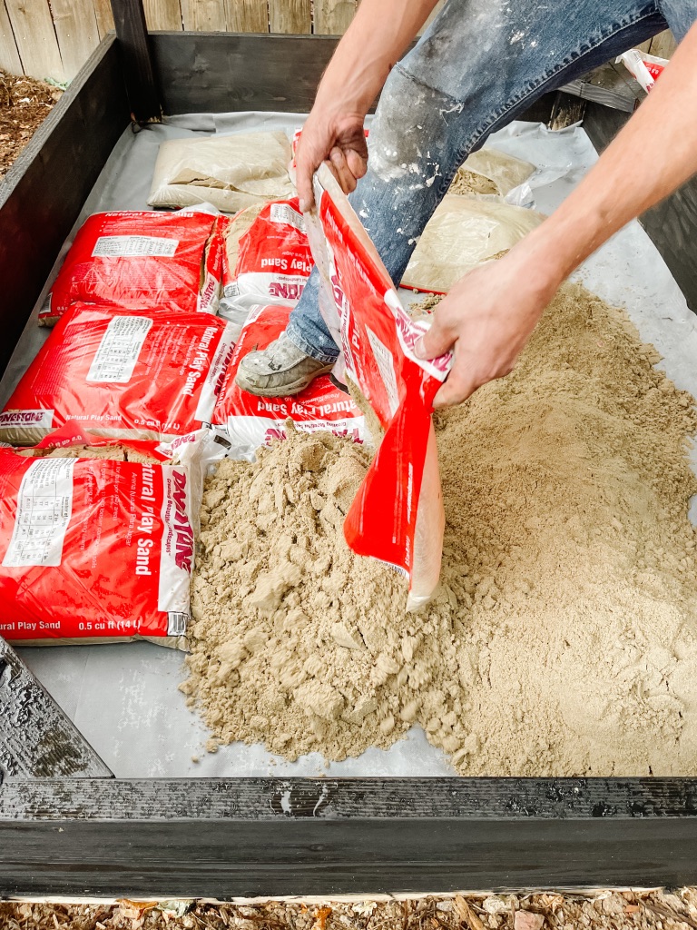 adding play sand to diy sandbox 