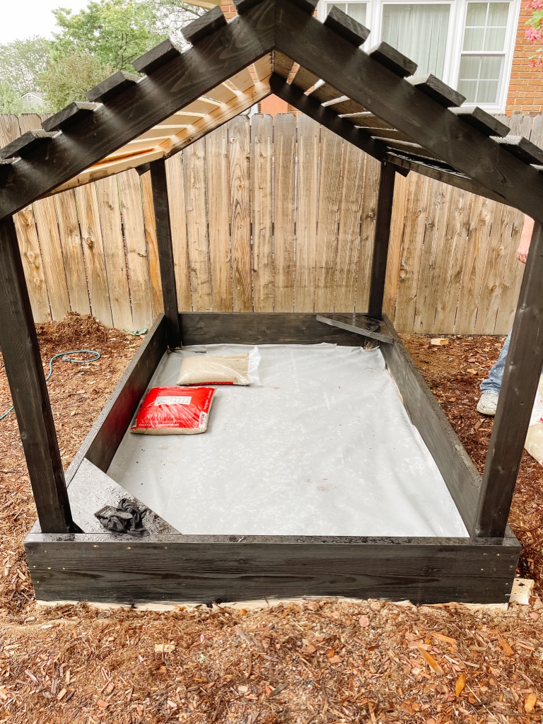 adding landscaping fabric to DIY sandbox