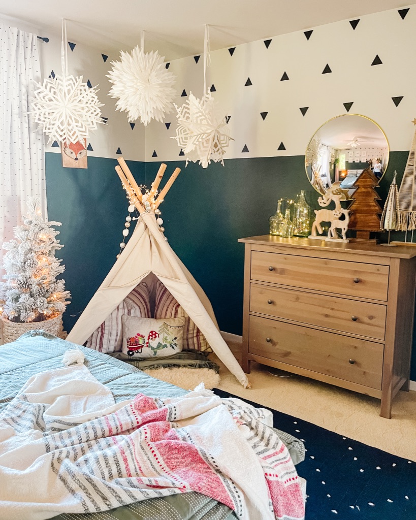 Colorful & Whimsical Christmas Kid Bedroom Decor with teepee, snowflake paper lanterns, and multi-colored stripe throw 
