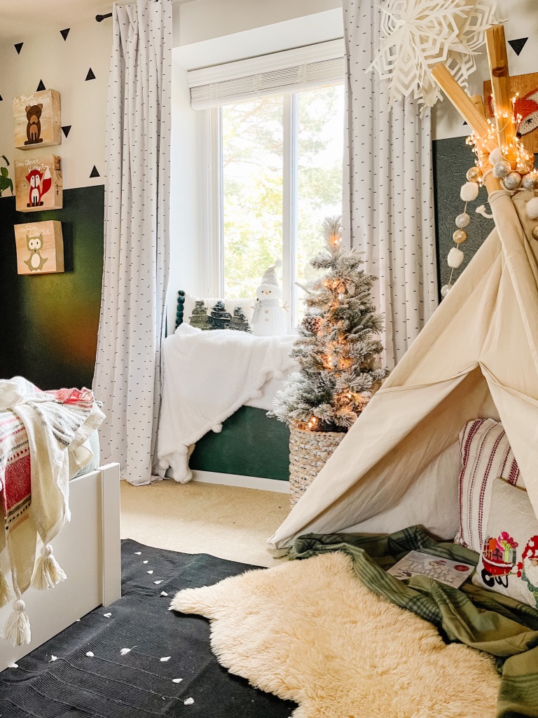 Colorful & Whimsical Christmas Kid Bedroom Decor with window seat, small flocked christmas tree and DIY canvas teepee with pom pom garland