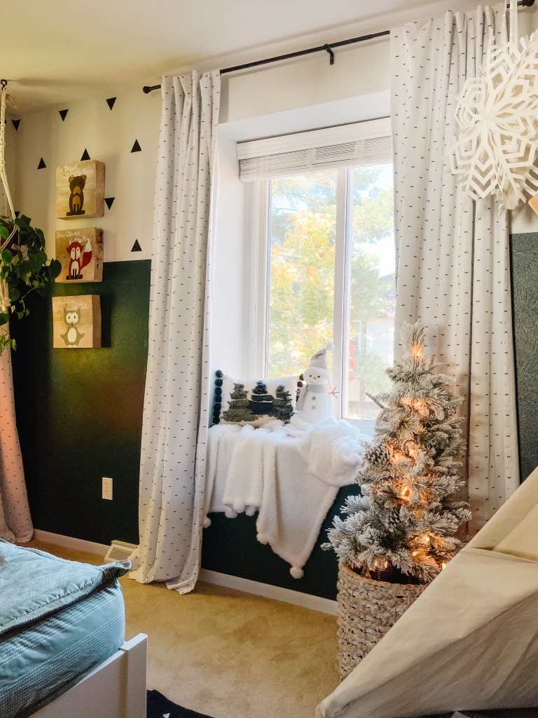 Kid's bedroom Christmas decor with 3' flocked Christmas tree from Walmart and window seat reading nook with white sherpa throw