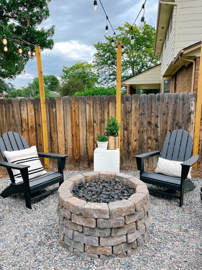Small backyard makeover with DIY Propane Fire Pit Area with Polywood Black Adirondack Chairs from Wayfair
