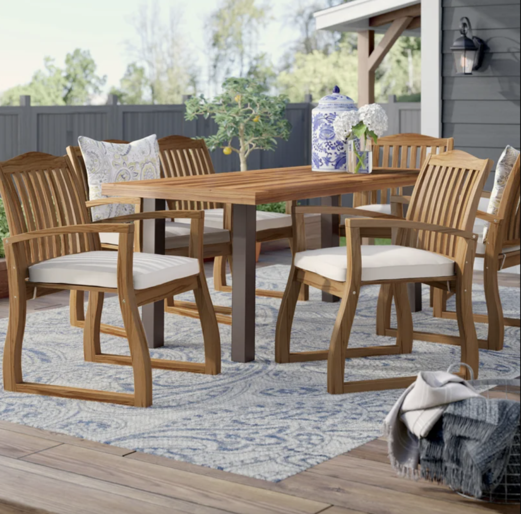 wood outdoor dining table set with white cushions