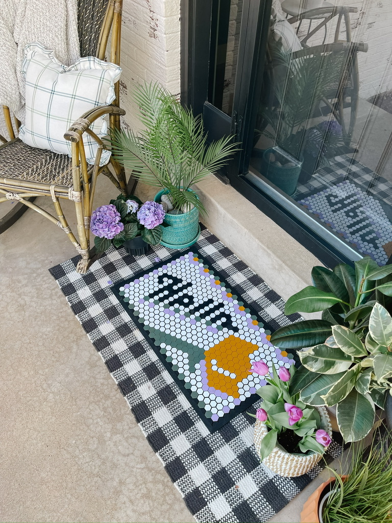 Front Porch Decorating Ideas: doormat, potted plants, and outdoor throw pillows